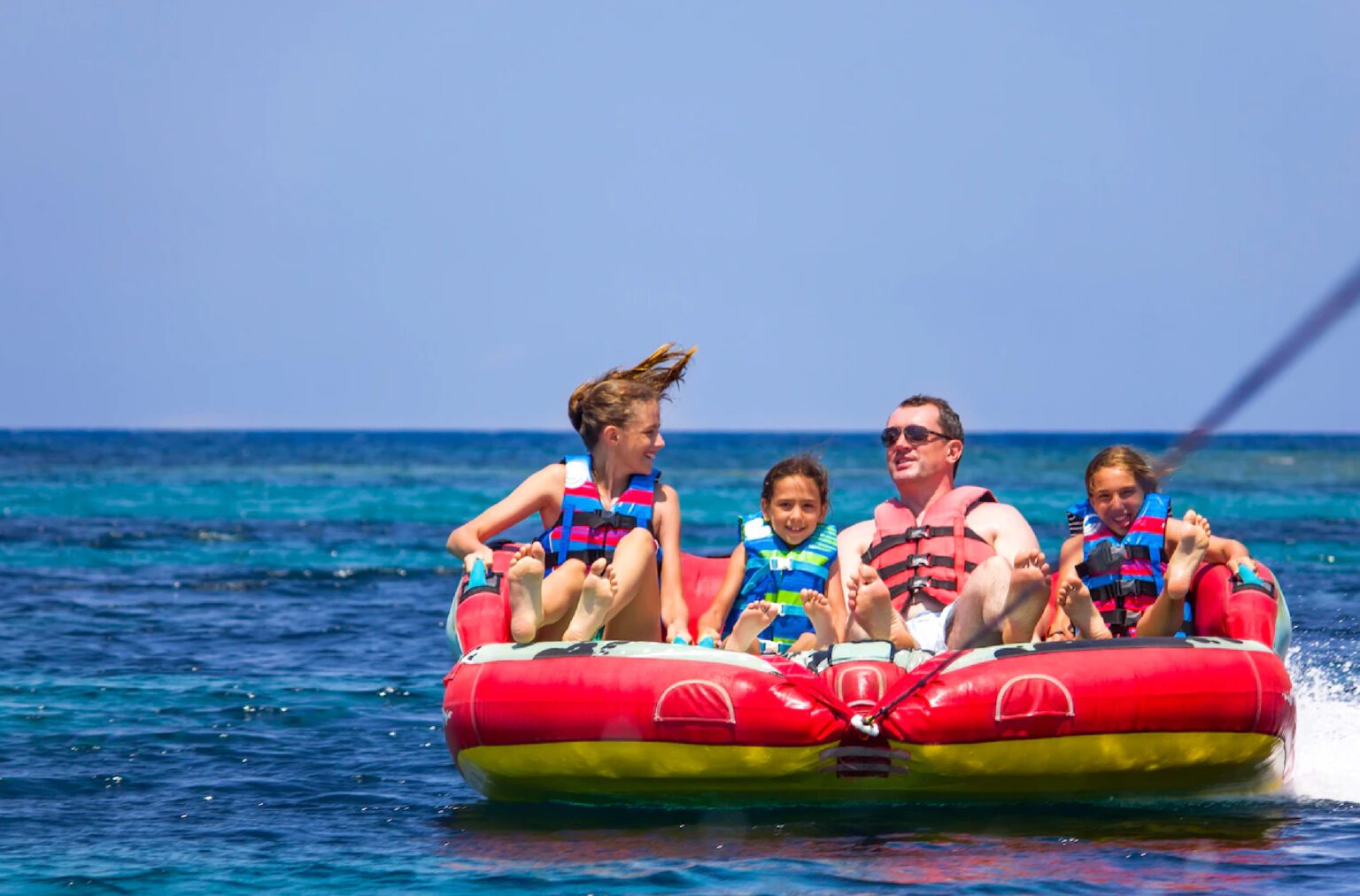 A family experiencing the thrill of gliding through the waves on Donut ride