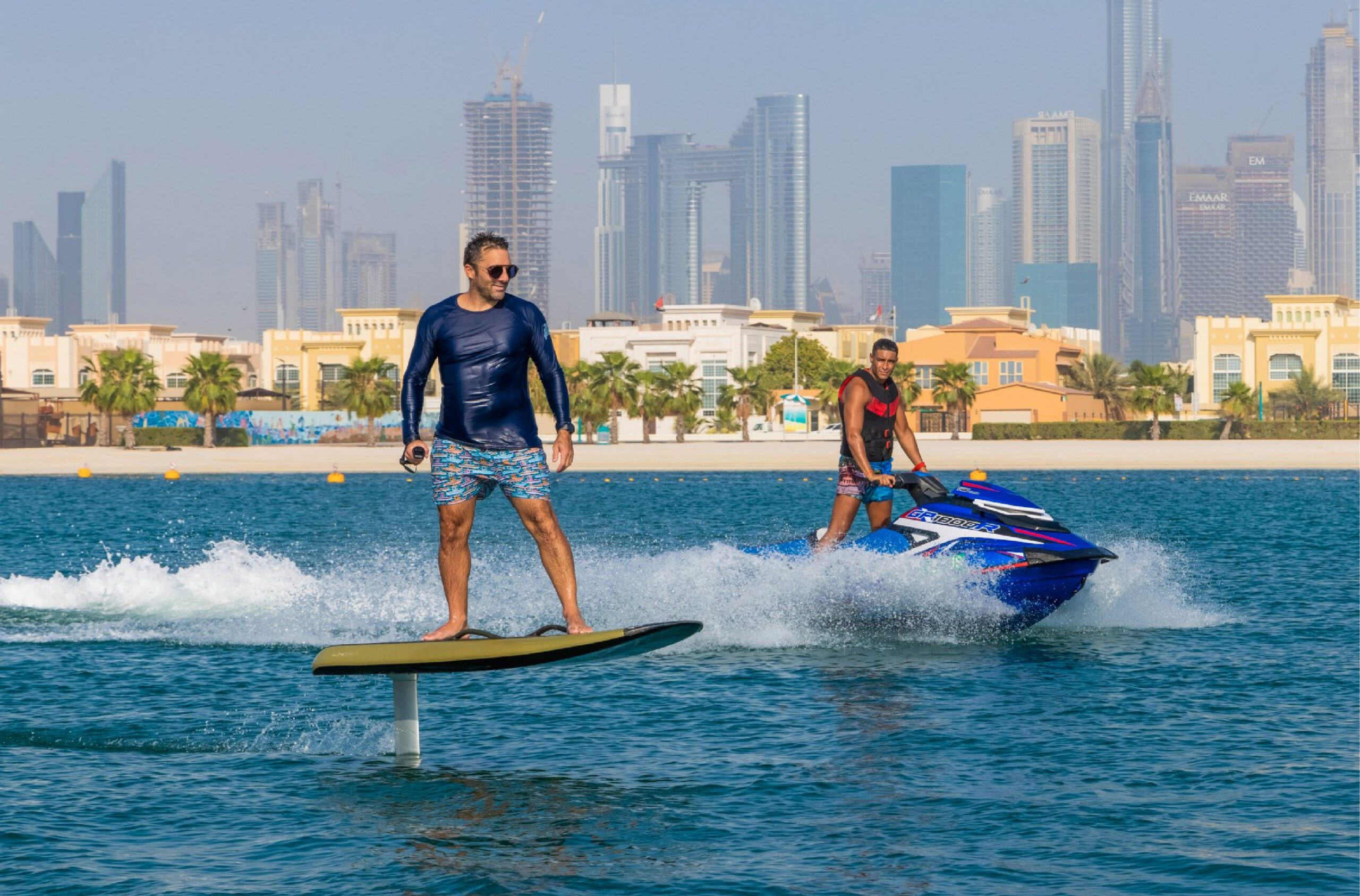 Man enjoying Electronic Surf Board overlooking Dubai skyline