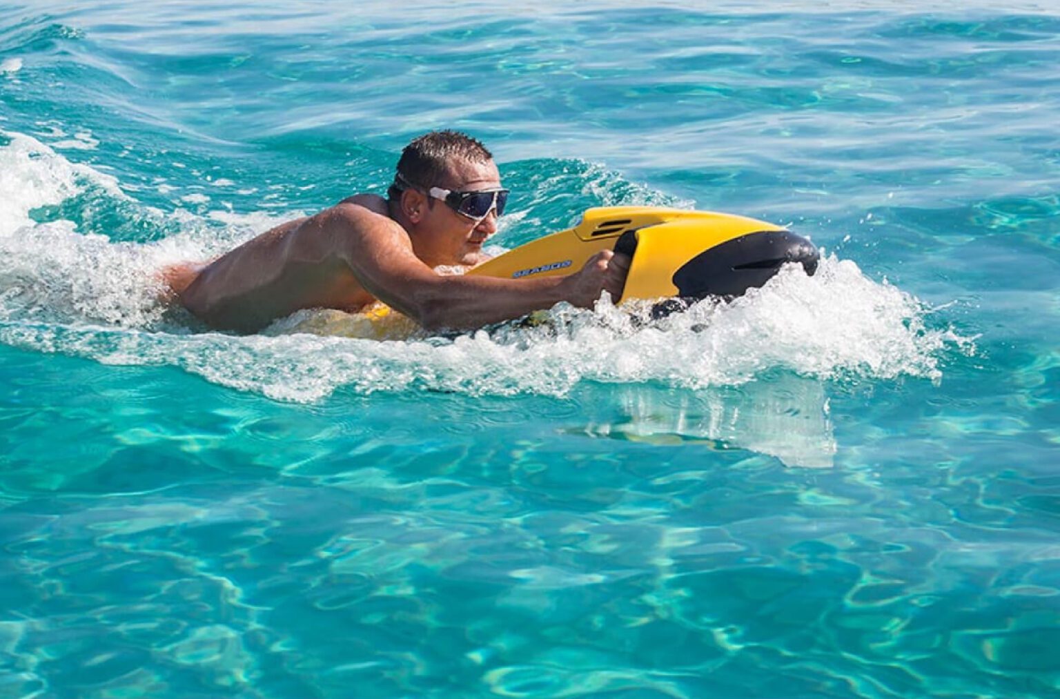 A man soaring on the dancing waves on seabob from Dubai Yachts