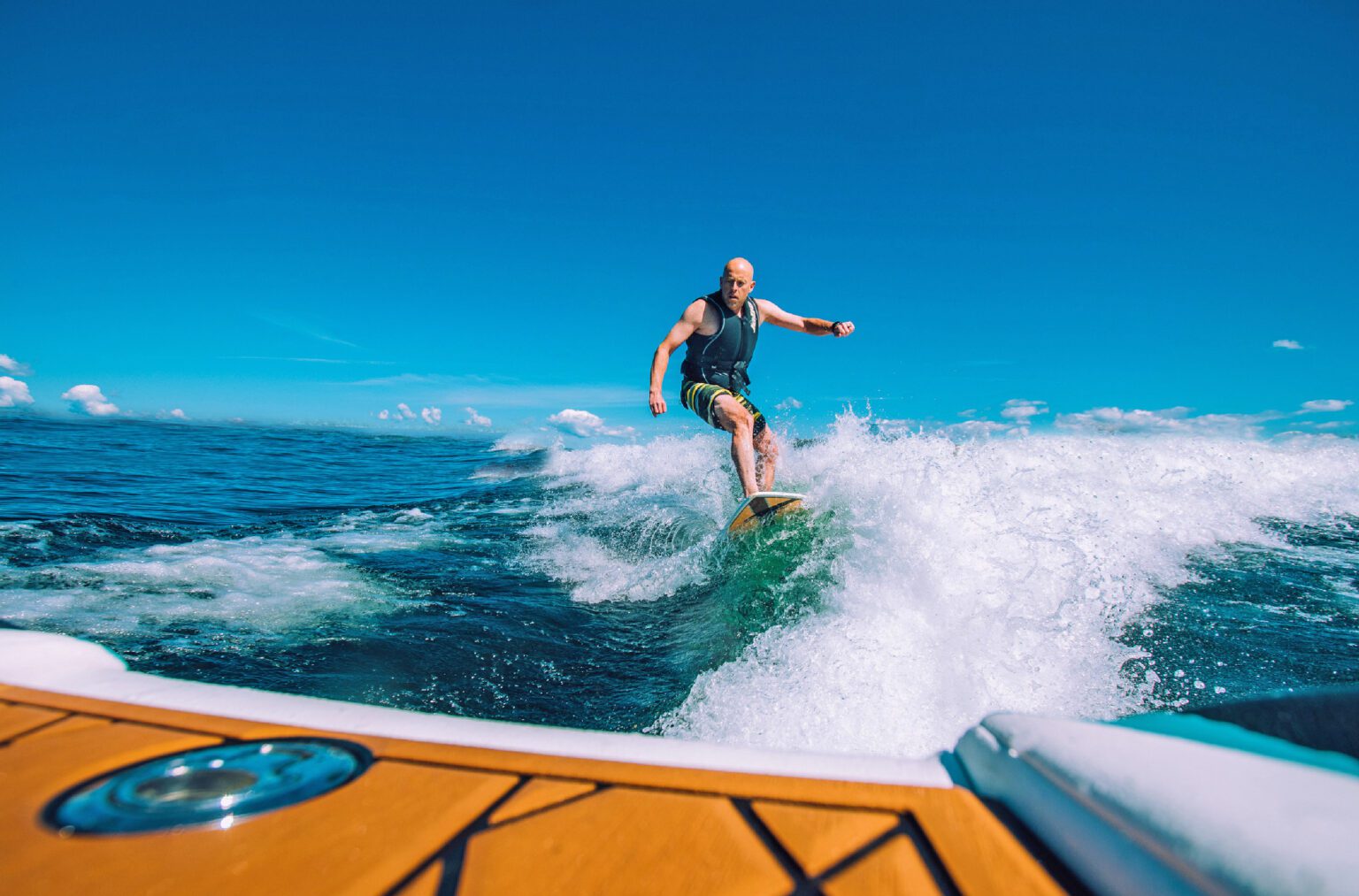 A man wake surfing through the waves