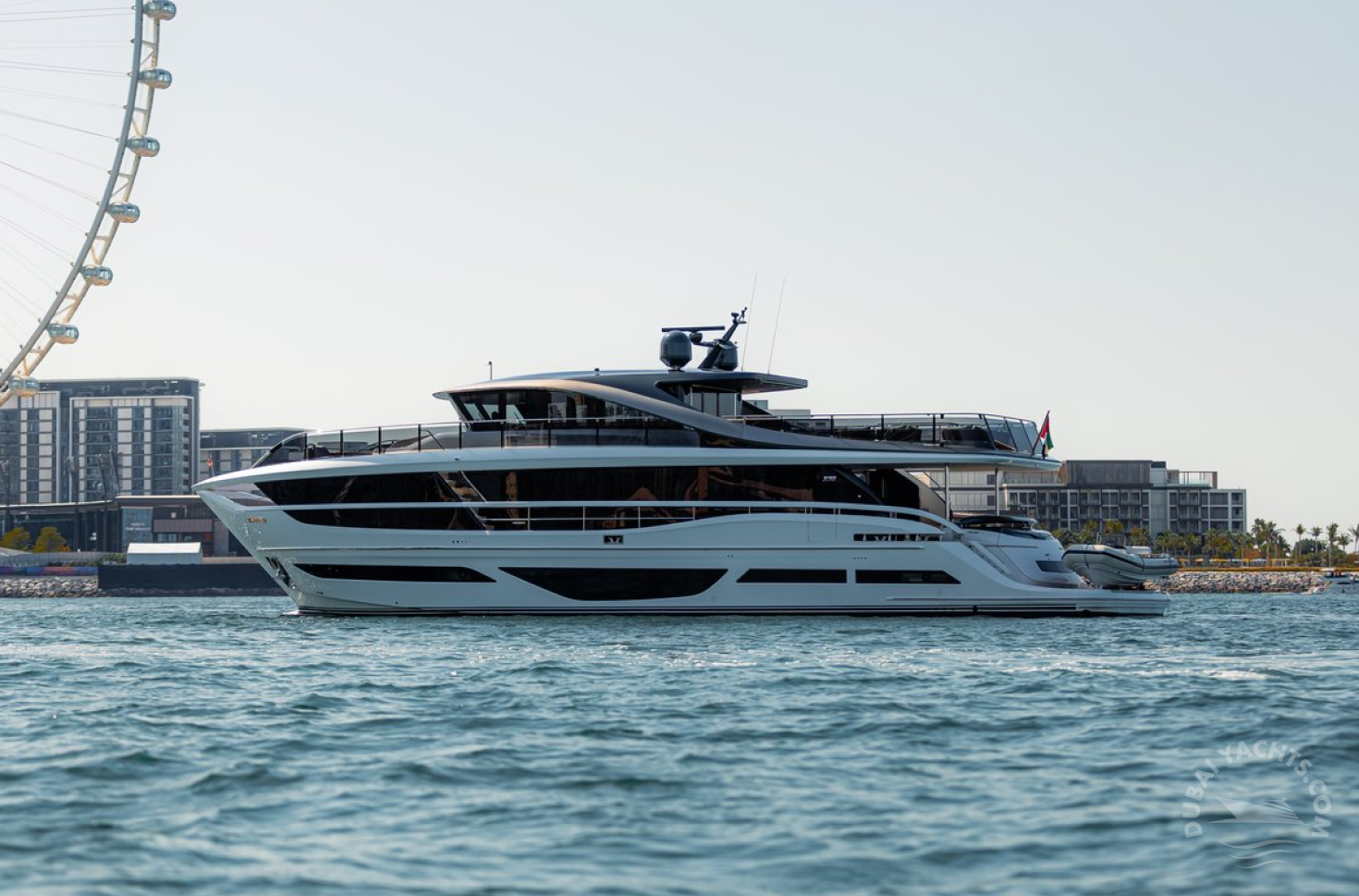 The view of Princess 95 ft Aura luxury yacht against the backdrop of Ferris Wheel